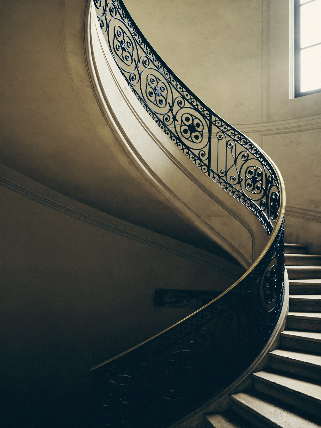 Curved stone staircase with wrought-iron balustrade at No. 4 Chancery Court